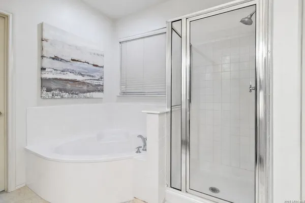 a bathroom with a glass shower door