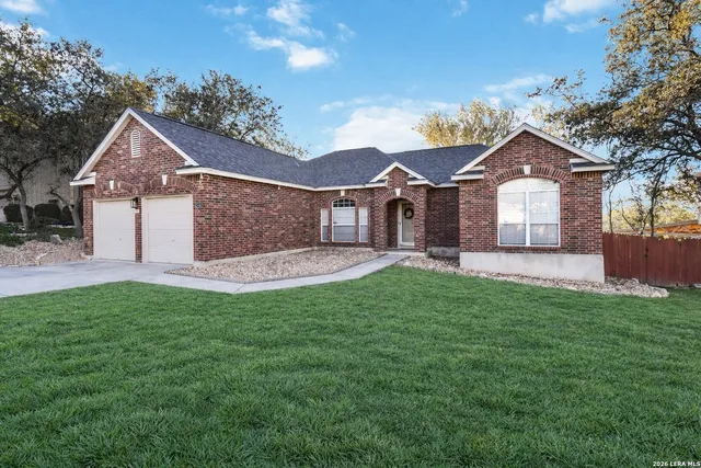 a front view of a house with a garden and yard