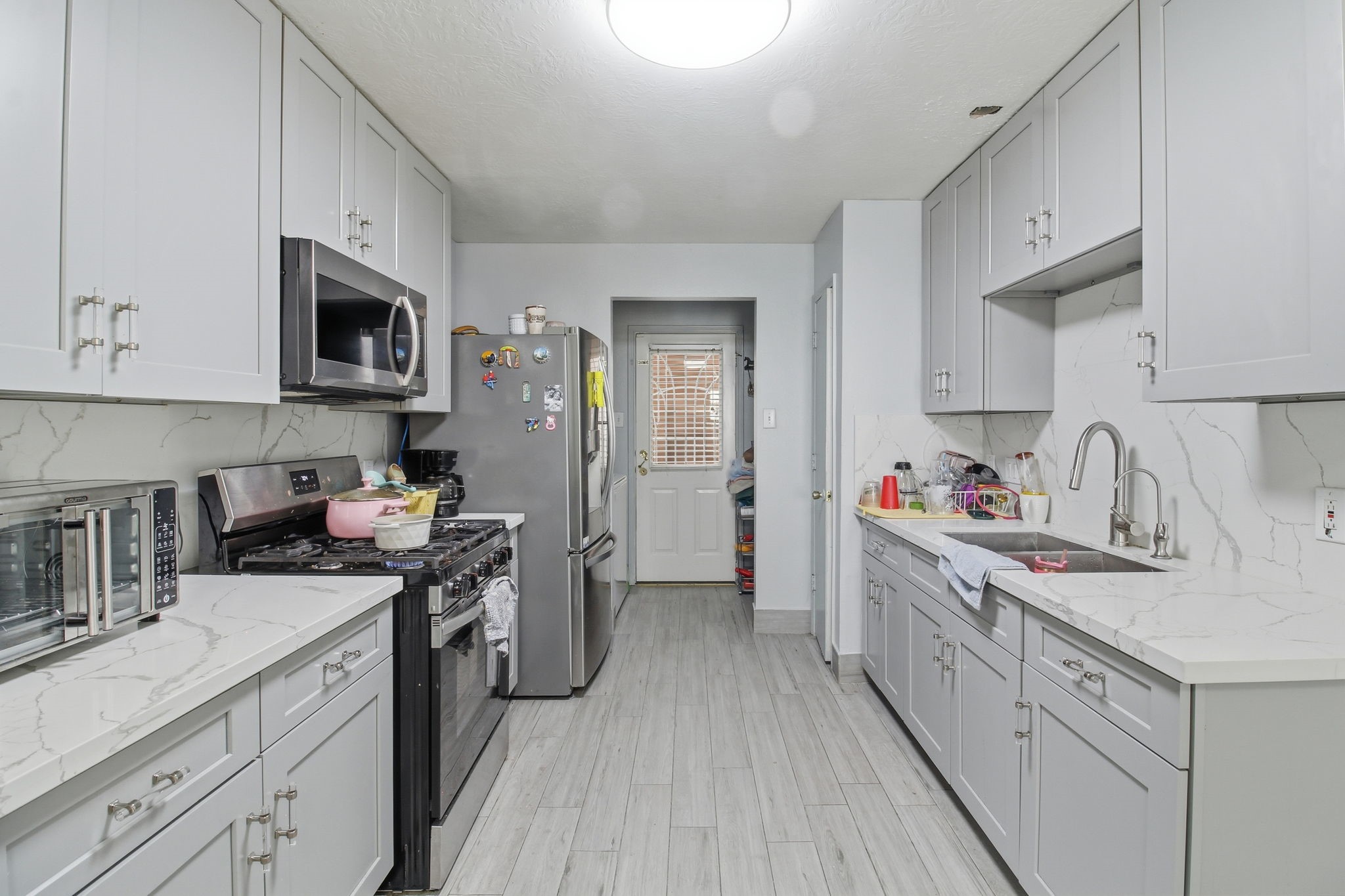 13106 Cherryglade Court Houston, TX 77044 - Photo 26 of 26 a kitchen with stainless steel appliances granite countertop a sink stove refrigerator and cabinets