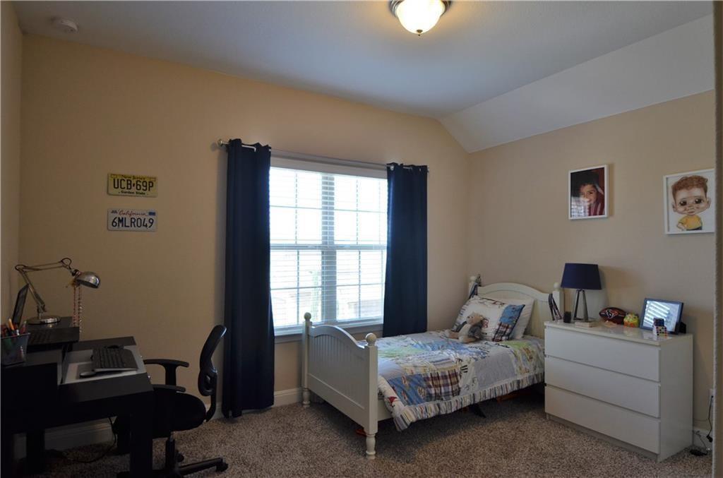 5629 Rio Chama Cove Austin, TX 78738 - Photo 18 of 34 Comfortable bedroom offers neutral walls, carpeting, and a window with blinds for natural illumination.