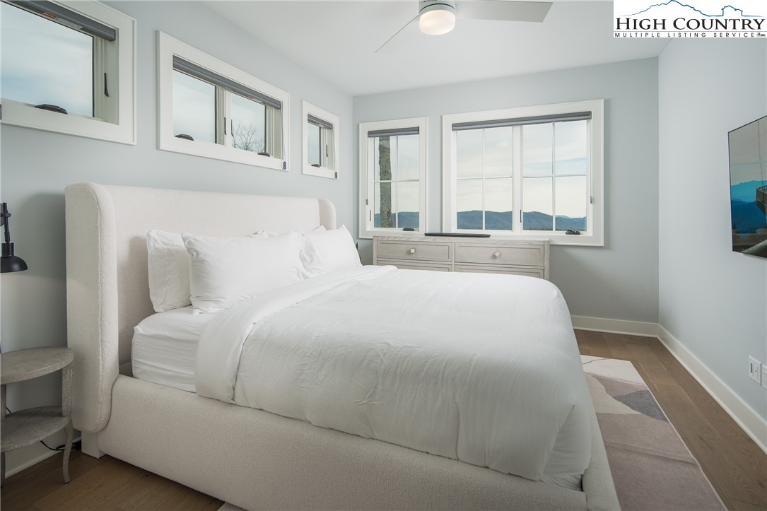 227 Calico Court Boone, NC 28607 - Photo 20 of 47 a large white bed in a white room