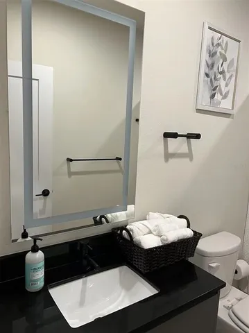 a bathroom with a toilet and a mirror