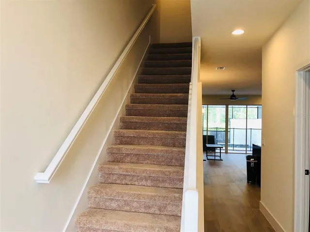 a view of entryway and hall with wooden floor