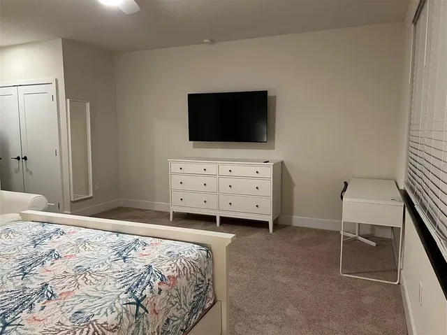 a bedroom with a bed and flat screen tv