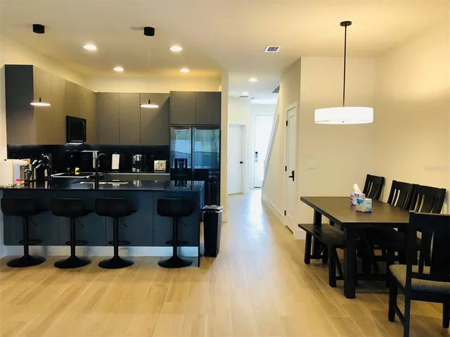 a kitchen with cabinets and chairs