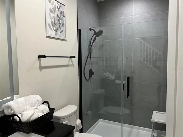 a bathroom with a toilet and a shower