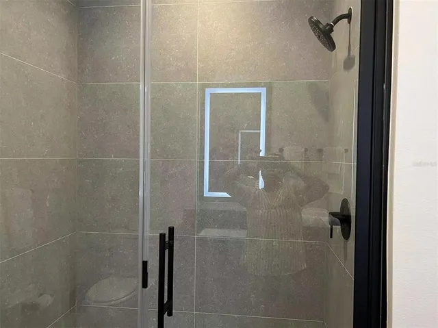 a bathroom with a glass shower door
