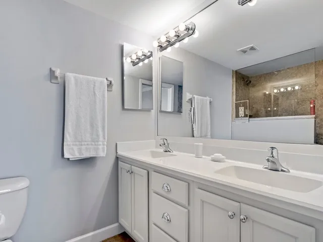 a bathroom with a sink double vanity and a mirror