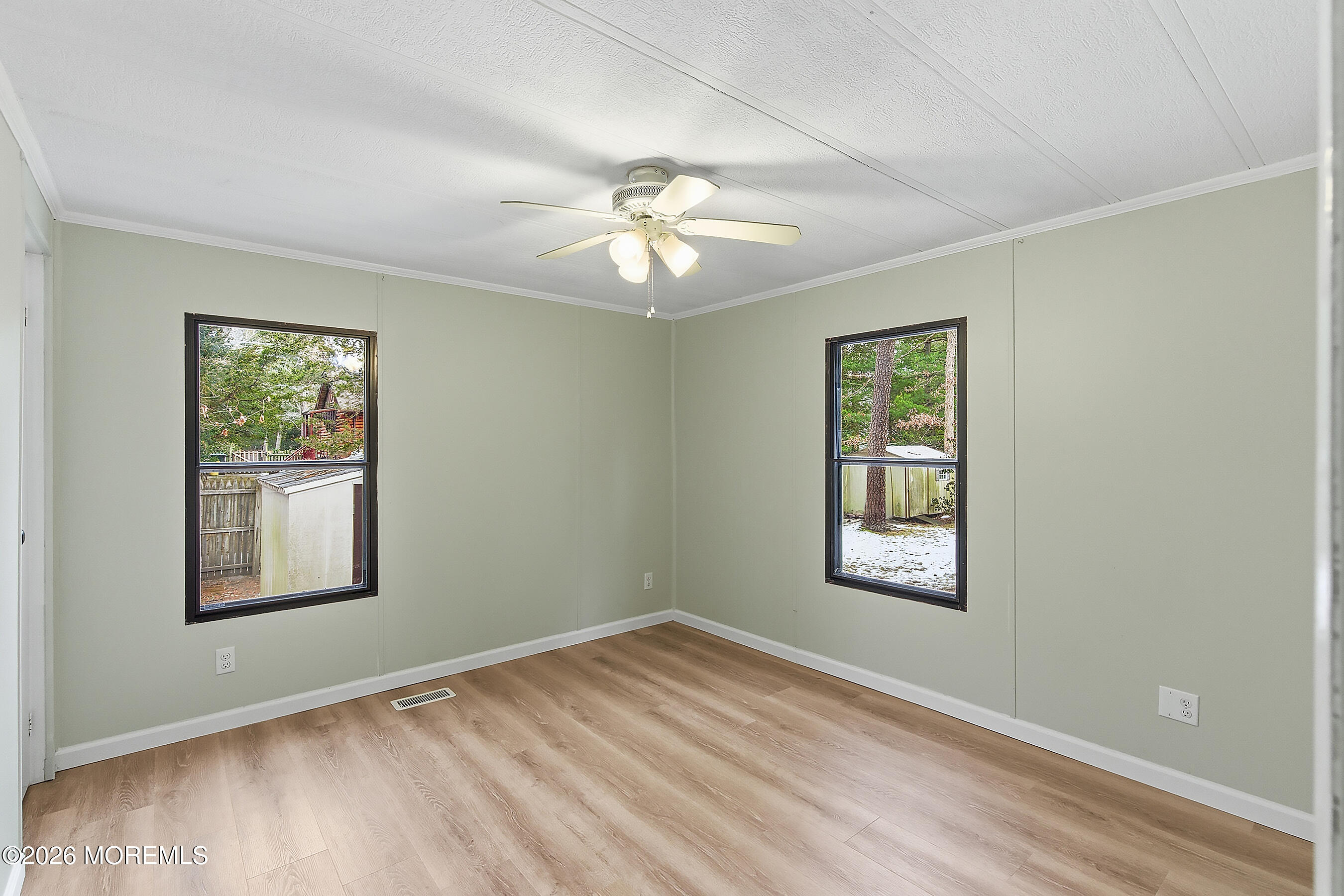 6 Loblolly Lane Jackson, NJ 08527 - Photo 14 of 20 a view of an empty room with a window and wooden floor