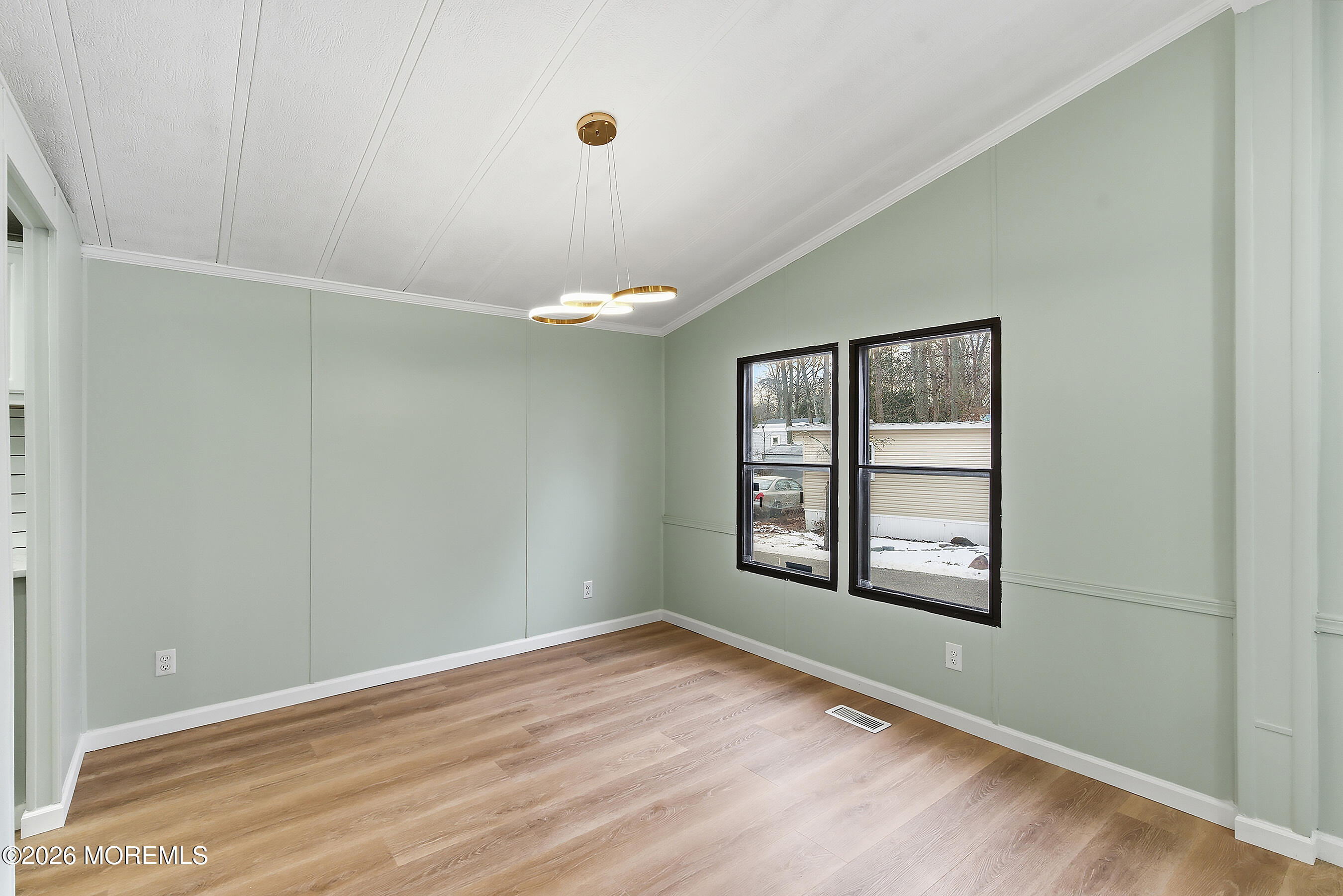 6 Loblolly Lane Jackson, NJ 08527 - Photo 7 of 20 an empty room with wooden floor and windows