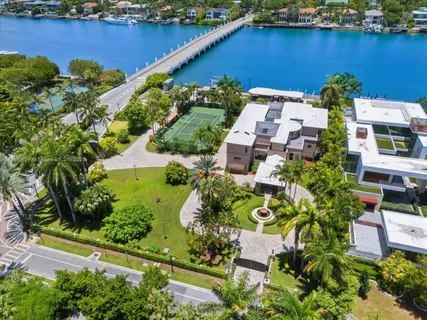 an aerial view of residential houses with outdoor space and lake view
