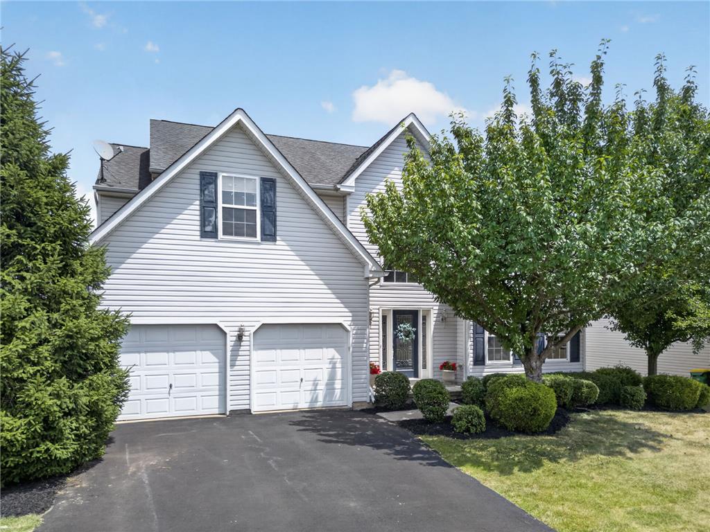 3821 Rittenhouse Road Lower Macungie Township, PA 18062 - Photo 2 of 62 A well-maintained facade features double garage doors and mature landscaping framing the inviting entry.