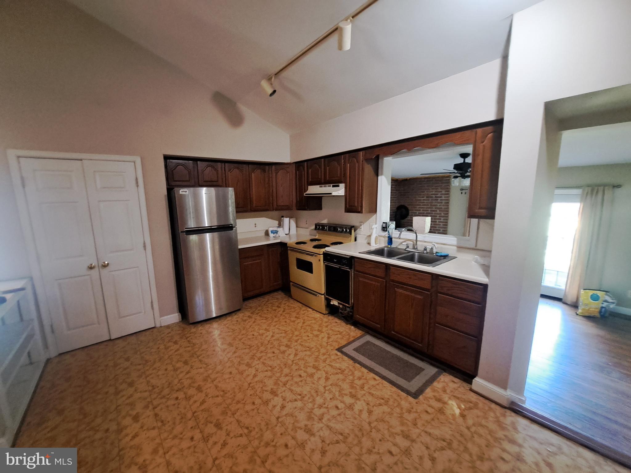 24401 River Road Dickerson, MD 20842 - Photo 29 of 43 a kitchen with stainless steel appliances granite countertop a refrigerator a sink dishwasher and a stove with wooden floor