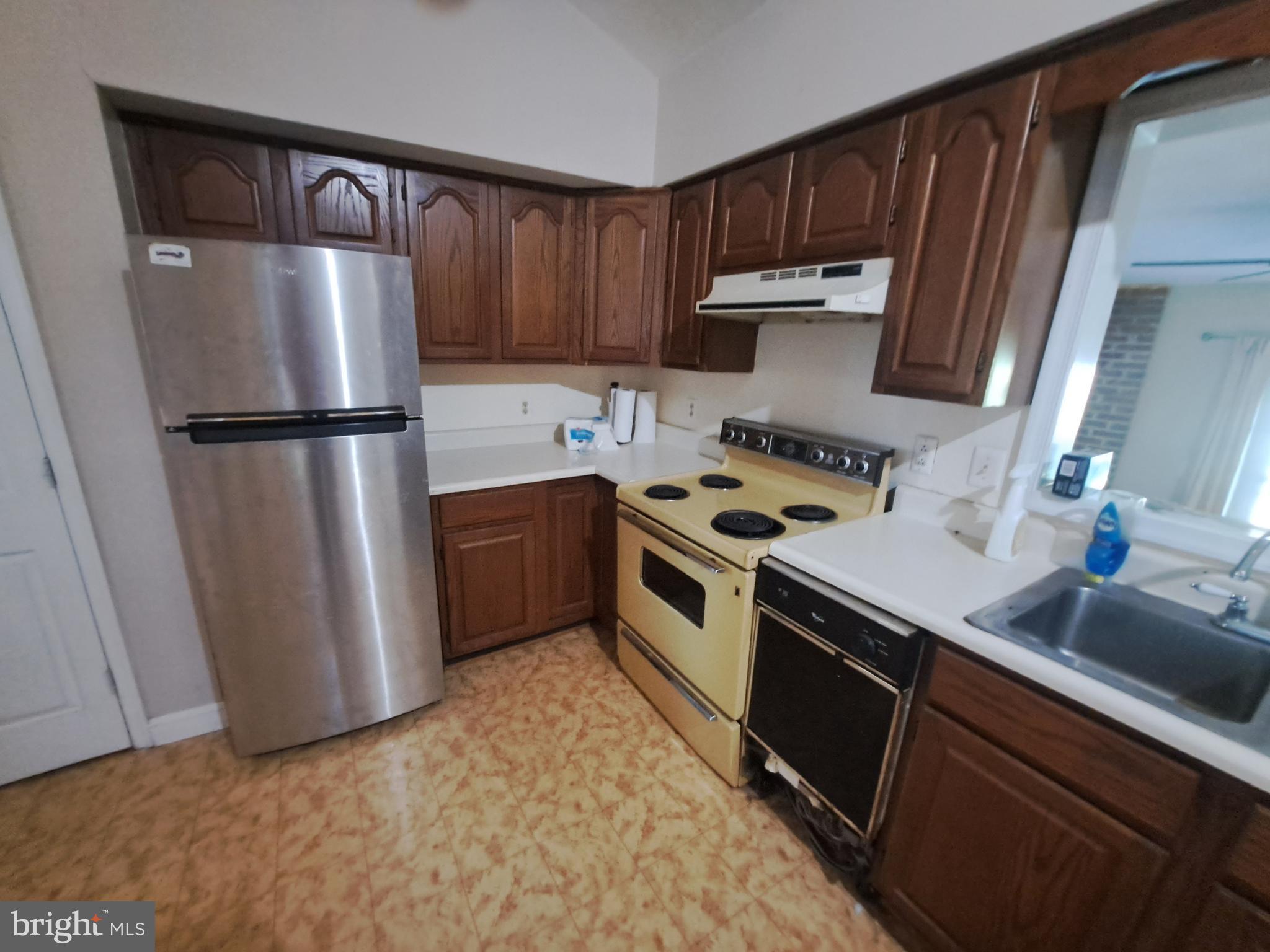 24401 River Road Dickerson, MD 20842 - Photo 31 of 43 a kitchen with a refrigerator sink and cabinets