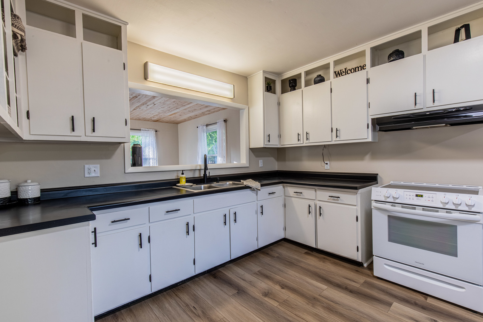 215 North Randolph Street Princeton, IL 61356 - Photo 7 of 24 a kitchen with granite countertop white cabinets and white appliances