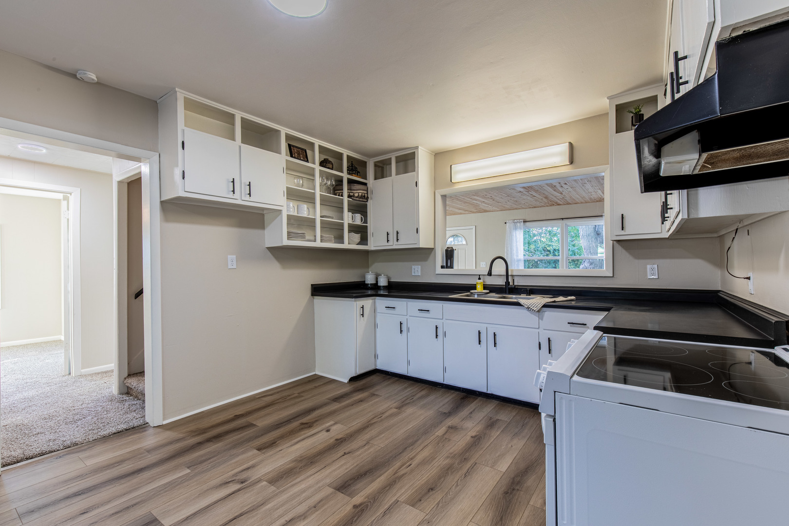 215 North Randolph Street Princeton, IL 61356 - Photo 8 of 24 a kitchen with granite countertop a sink cabinets and stainless steel appliances