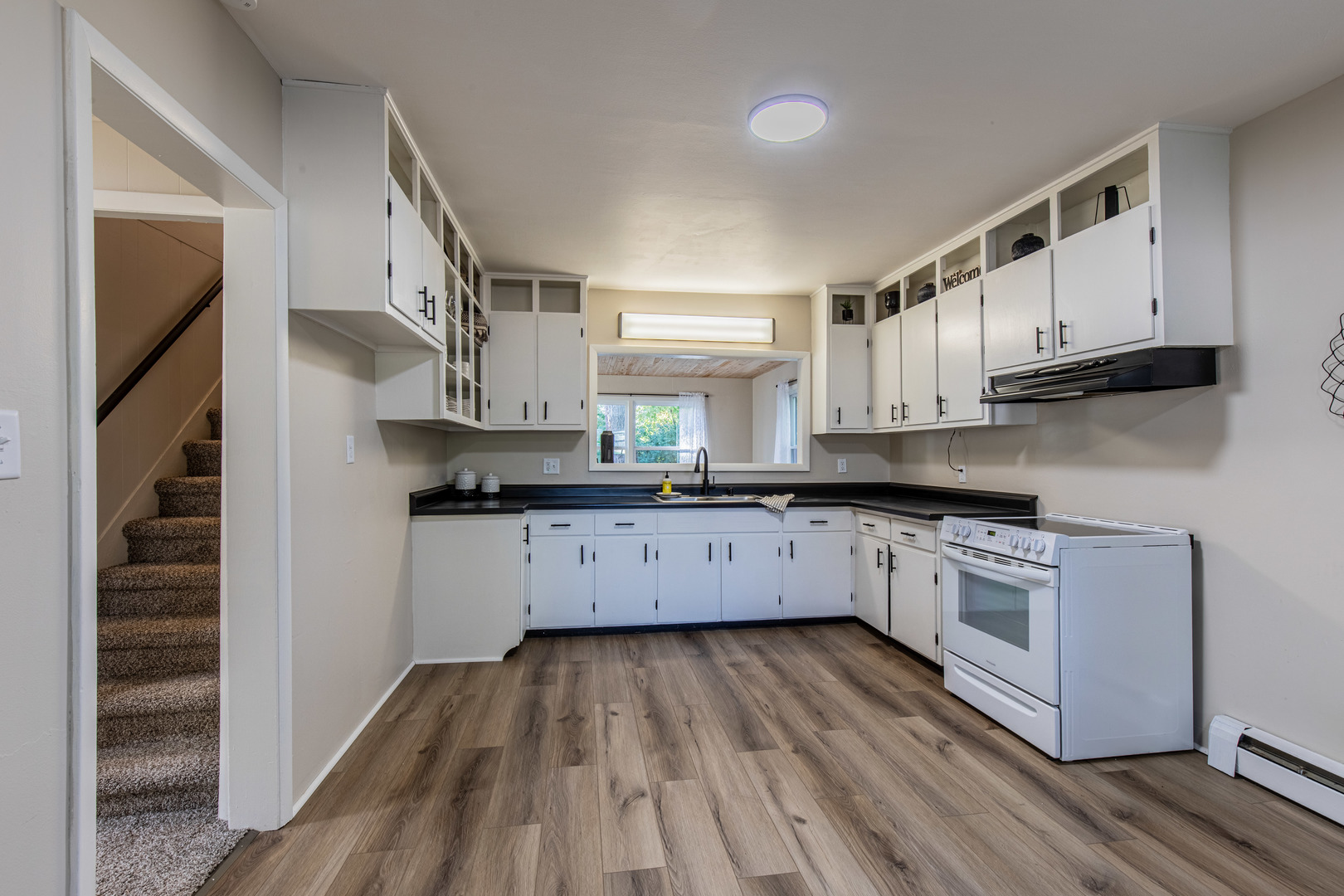 215 North Randolph Street Princeton, IL 61356 - Photo 9 of 24 a kitchen with stainless steel appliances granite countertop a stove a sink and a refrigerator
