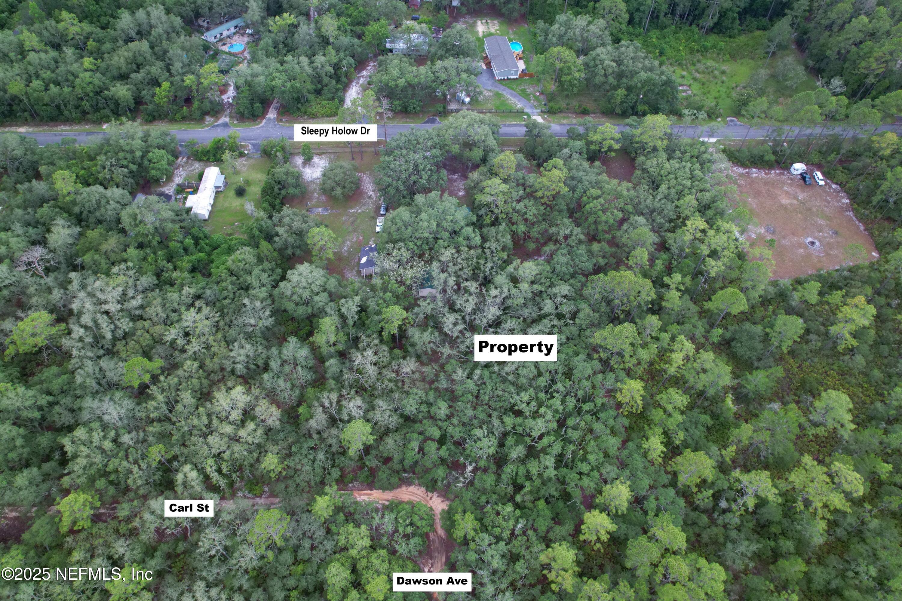 143 Dawson Avenue Interlachen, FL 32148 - Photo 2 of 15 an aerial view of residential house with outdoor space and parking