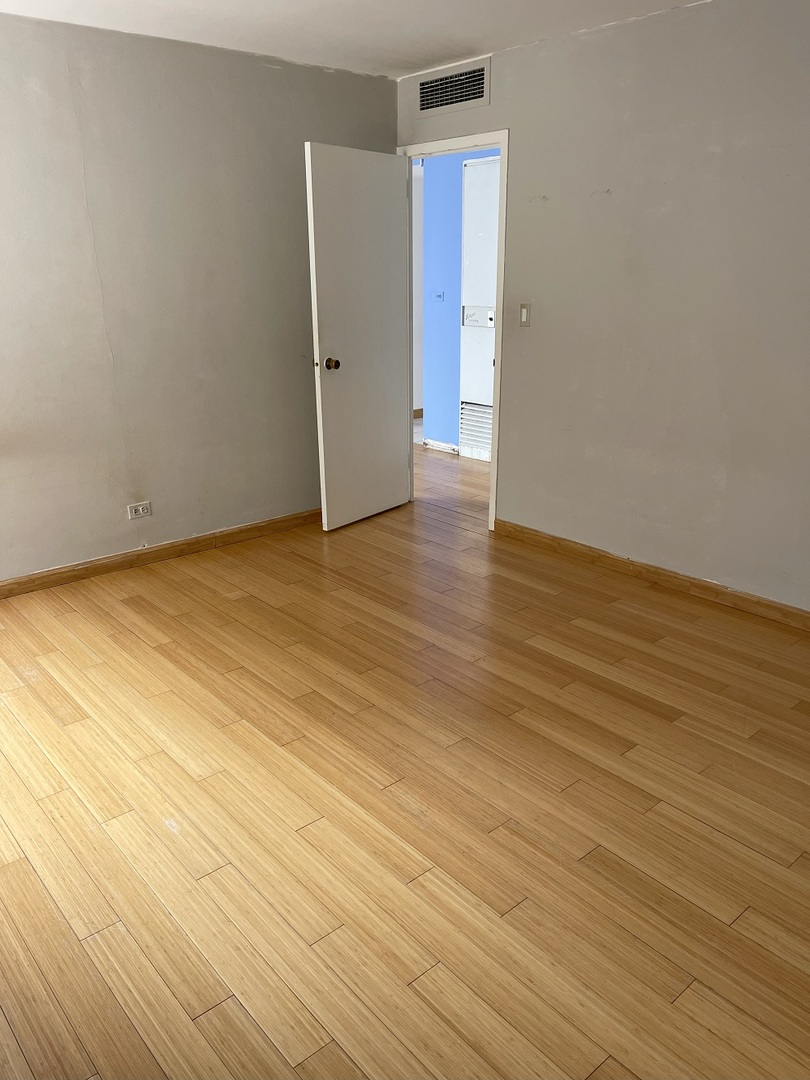 6301 North Sheridan Road, Unit 22F Chicago, IL 60660 - Photo 9 of 11 a view of an empty room with wooden floor