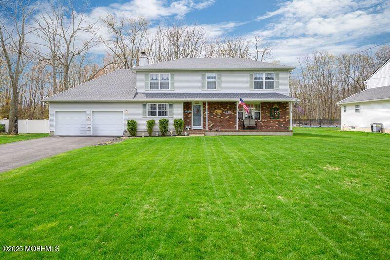 a view of a house with a yard and sitting area