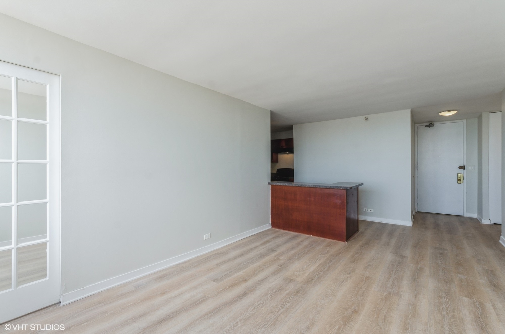 655 West Irving Park Road, Unit 3006 Chicago, IL 60613 - Photo 7 of 23 wooden floor in an empty room with a window