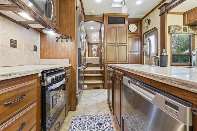 a kitchen with stainless steel appliances granite countertop a stove and a refrigerator