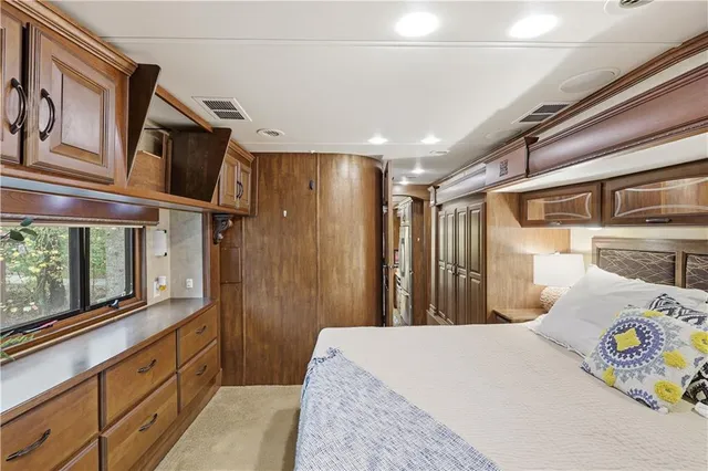 a bedroom with a bed and a large window