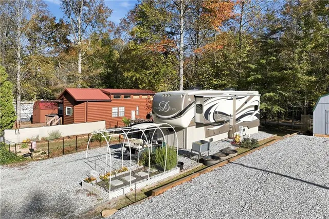 an aerial view of a house with swimming pool and sitting area