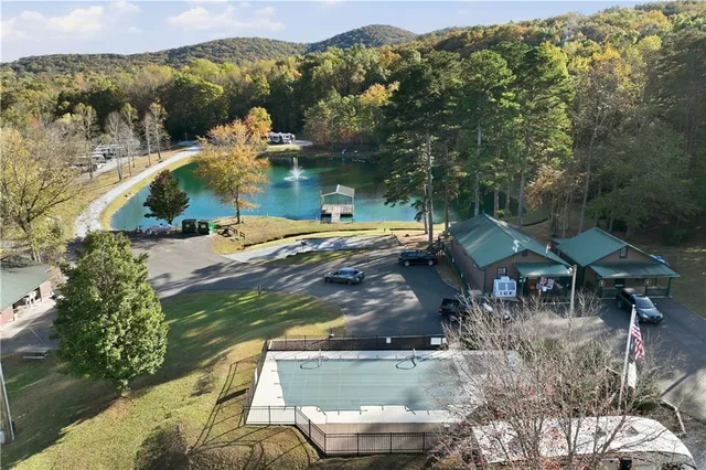 an aerial view of a house with a yard swimming pool and mountain view