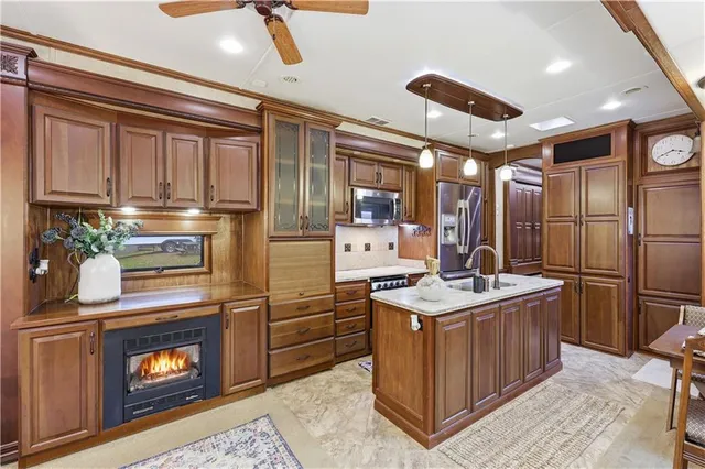 a kitchen with stainless steel appliances granite countertop a stove a refrigerator and a microwave