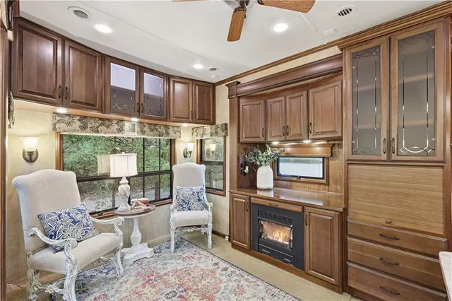 a living room with furniture a fireplace and a flat screen tv