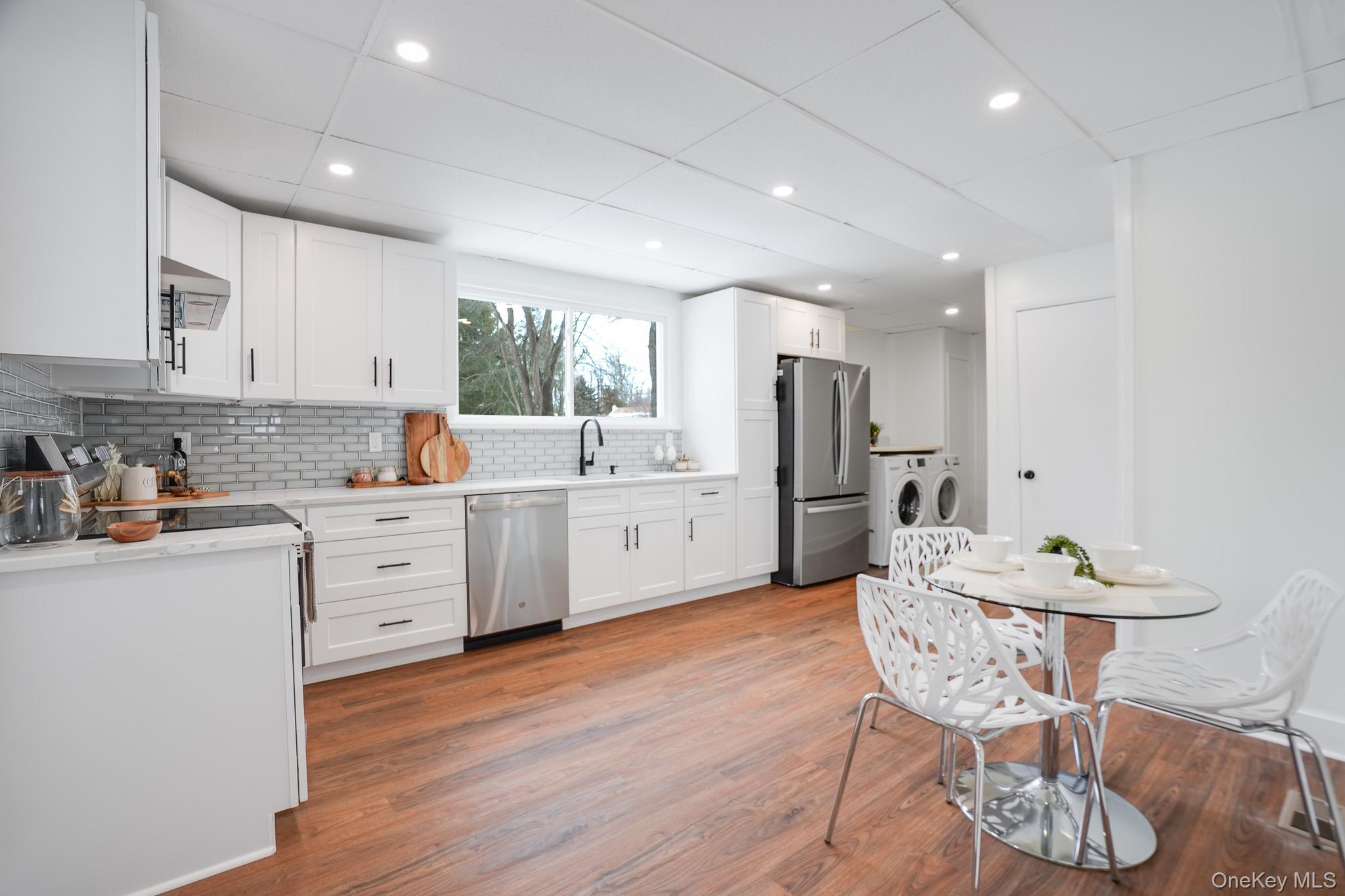 20 Shirley Avenue Fishkill, NY 12524 - Photo 13 of 38 Eat in kitchen featuring stainless steel appliances with custom cabinets, quartz countertops, and recessed lighting.
