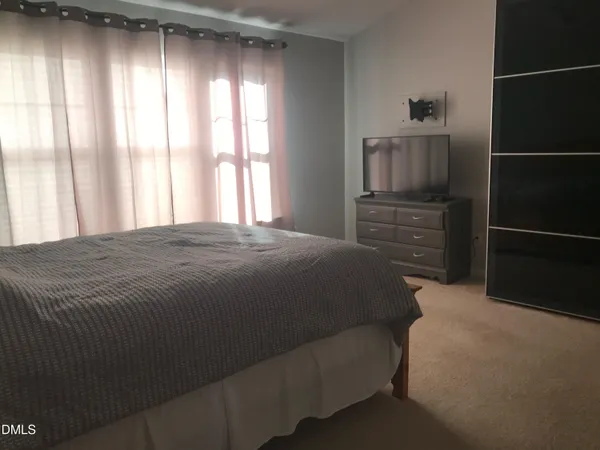 a bedroom with a bed and a chair