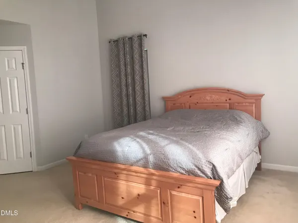 a bedroom with a bed and a desk
