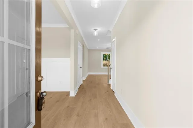 a view of a hallway with wooden floor