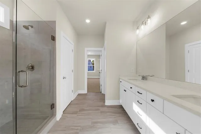 a bathroom with a double vanity sink and mirror