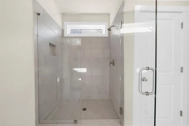 a bathroom with a glass shower door