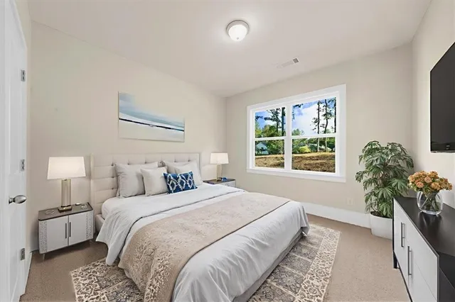 a bedroom with a bed and a potted plant