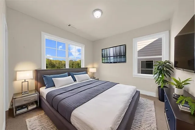 a bedroom with a bed and a flat screen tv
