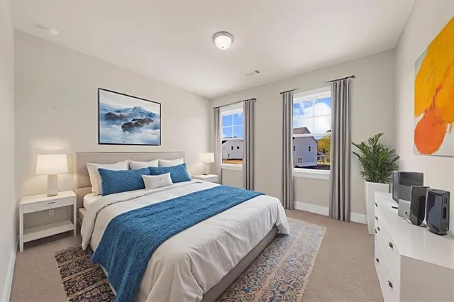 a bedroom with a bed and a painting on the wall