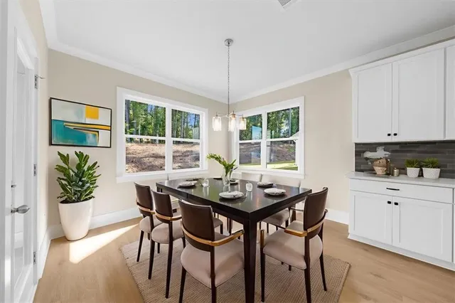 a view of a dining room with furniture window and wooden floor
