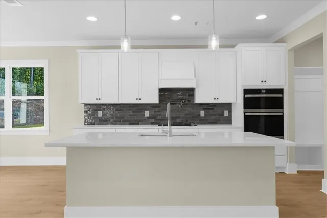 a large kitchen with stainless steel appliances and a refrigerator