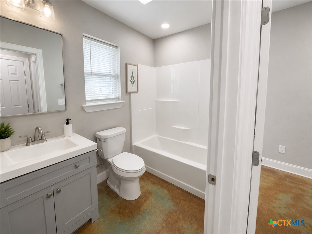 661 West Austin Street, Unit Q Luling, TX 78648 - Photo 5 of 9 a bathroom with a sink a toilet and shower