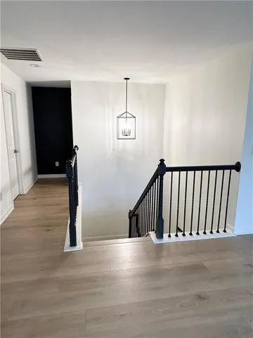 a view of entryway and hall with wooden floor