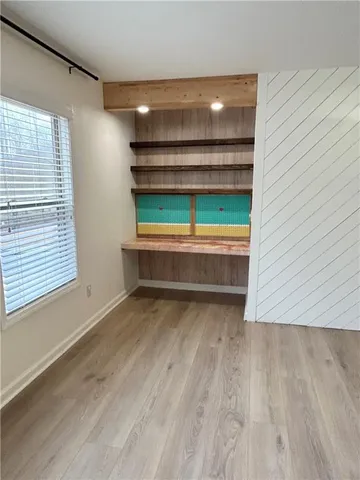 a room with wooden floor and a window