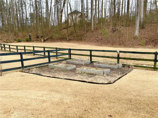 a backyard of a house with table and chairs