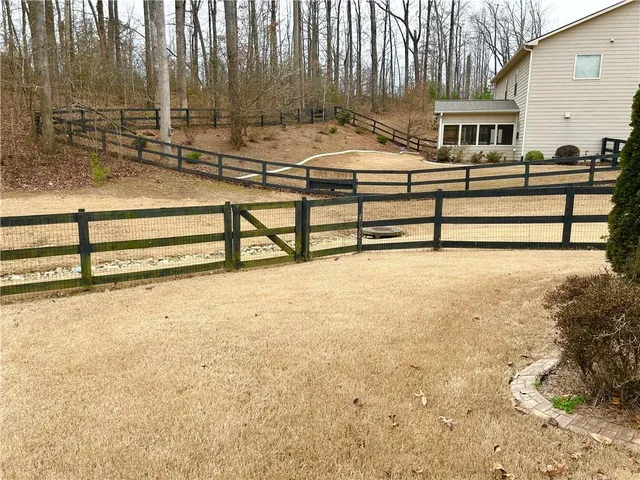 a front view of a house with a yard covered with snow