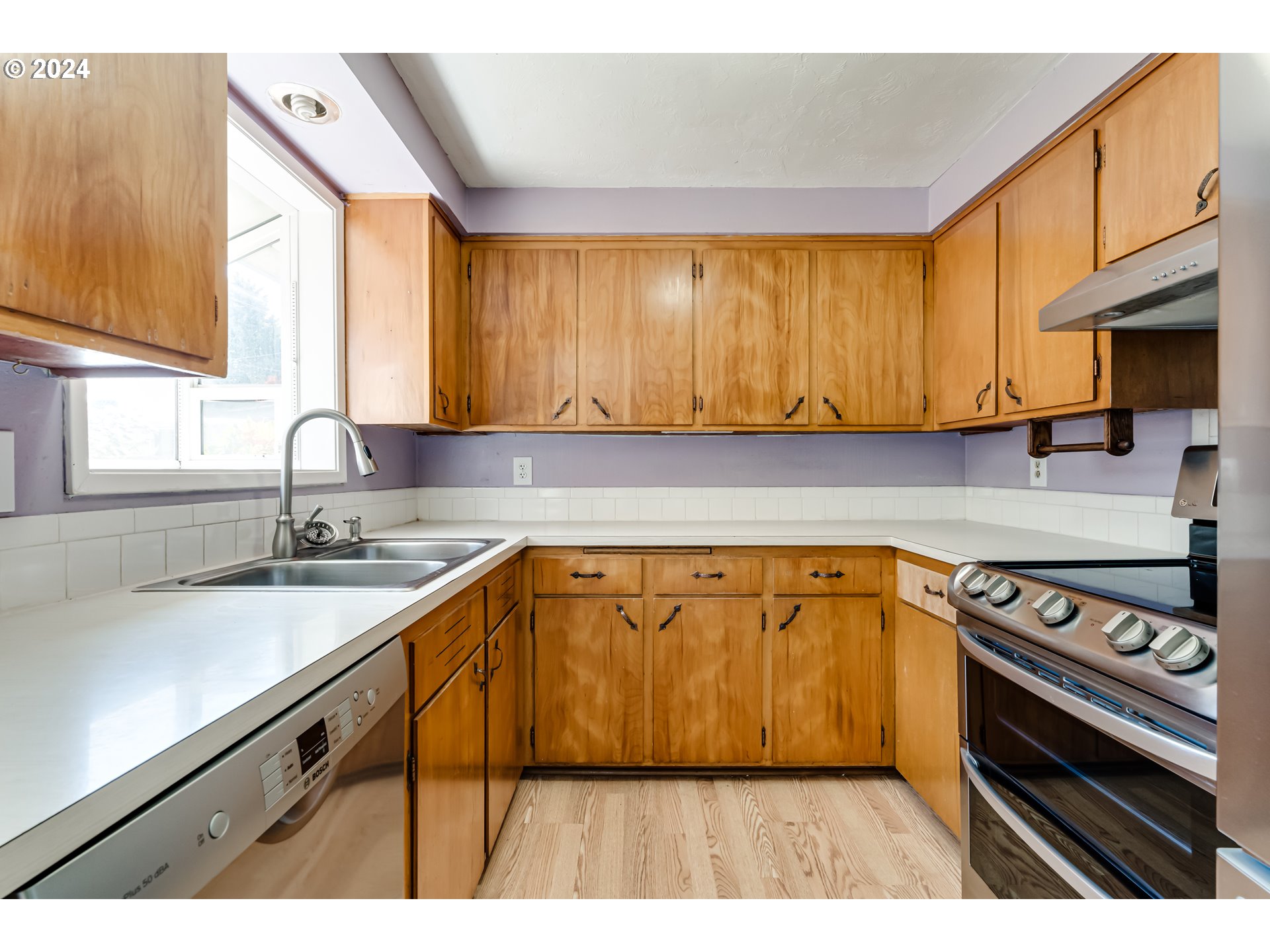 4115 Scottdale Street Eugene, OR 97404 - Photo 13 of 33 a kitchen with a sink a stove and cabinets