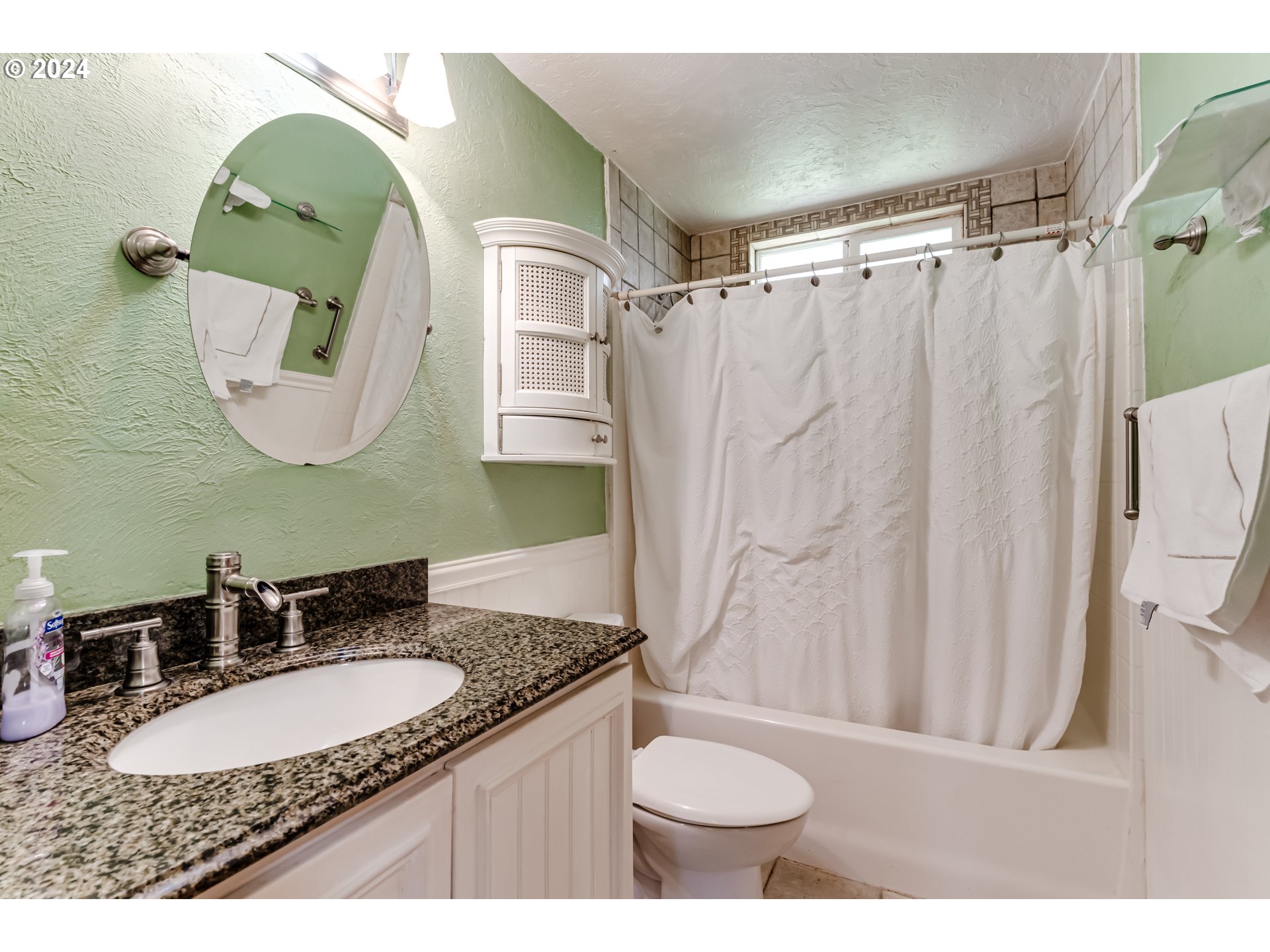 4115 Scottdale Street Eugene, OR 97404 - Photo 21 of 33 a bathroom with a granite countertop sink mirror and vanity