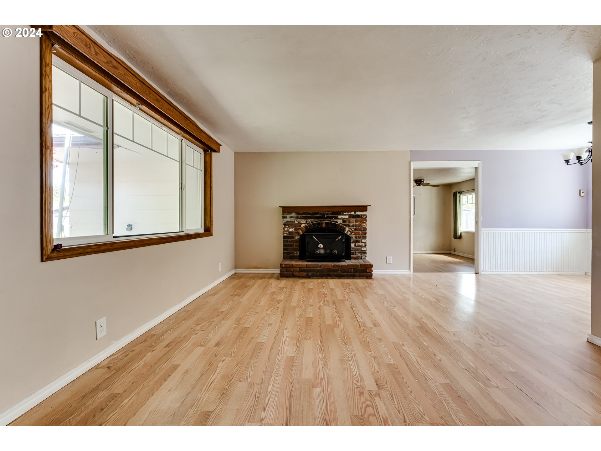 4115 Scottdale Street Eugene, OR 97404 - Photo 8 of 33 a view of empty room with a fireplace and wooden floor